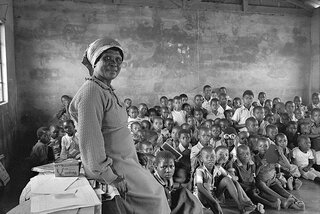 Teacher with her class of eighty children. Amouti